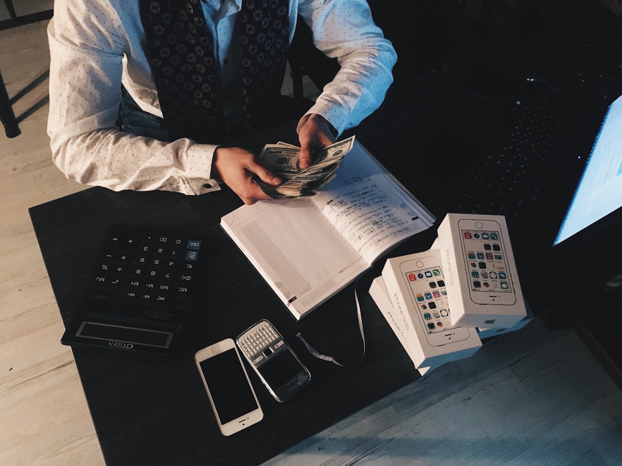 An accountant sorts money at a table.