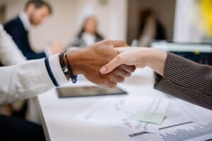 Two people shake hands.