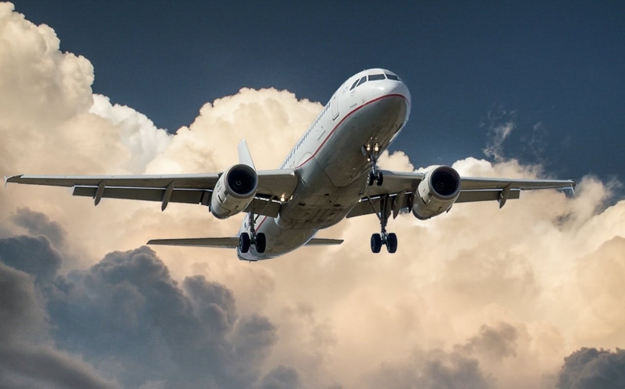 An airplane flies through a cloud.