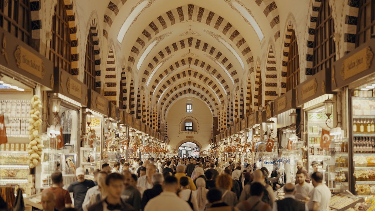 People walk through a crowded marketplace.