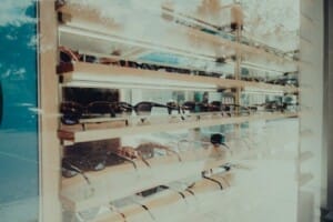 Glasses sit in a display at an optical store.