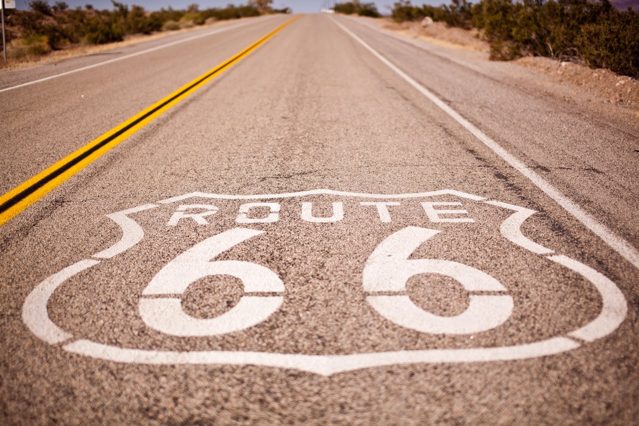 Route 66 is painted on a roadway.