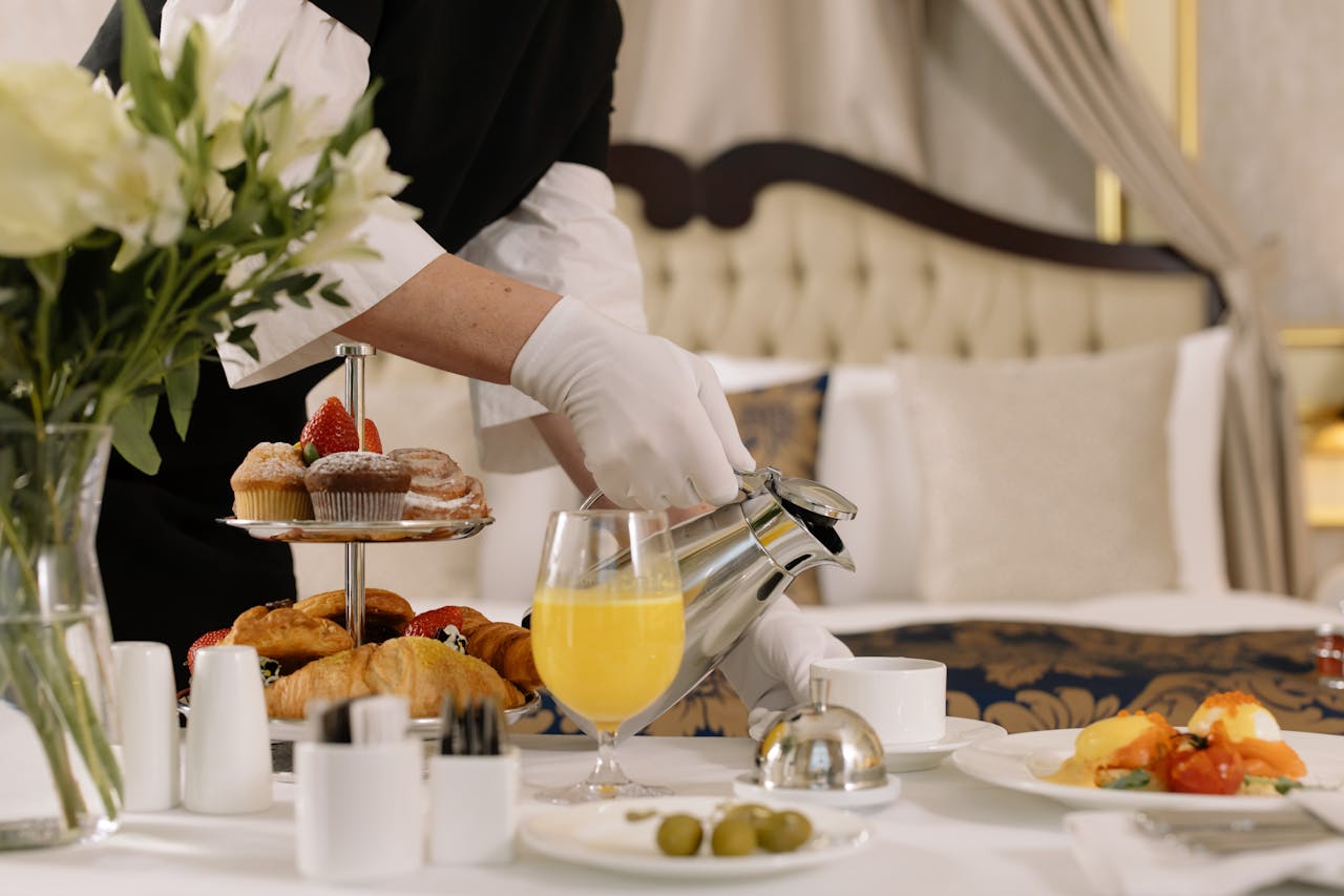 Someone serves drinks and food.