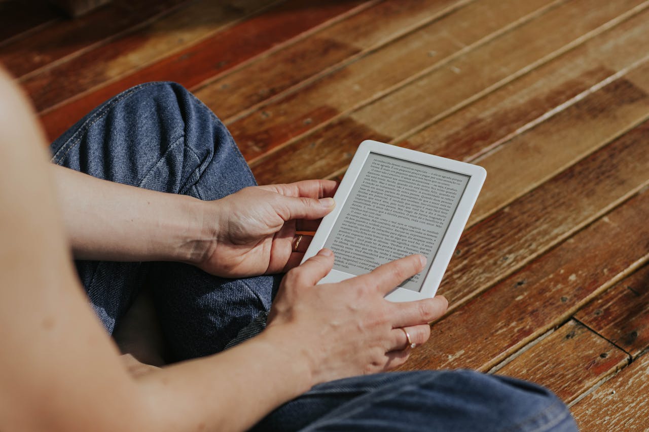 Someone reads on an e-reader device.