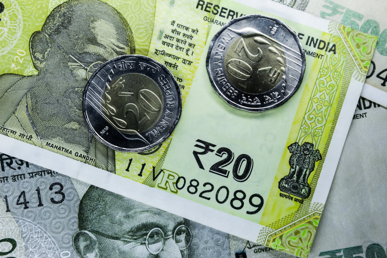 Coins sit on top of banknotes.