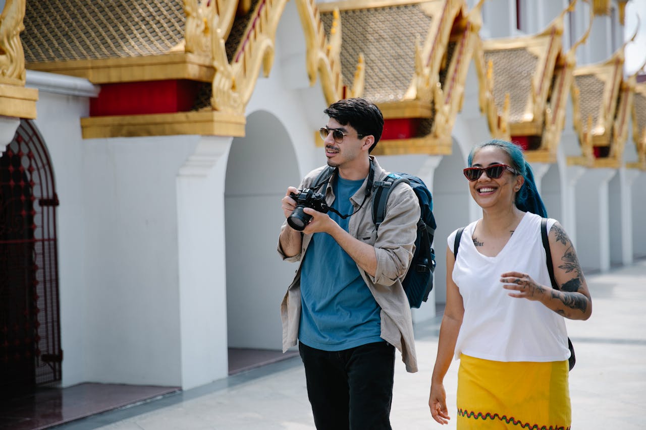 Two travelers walk in a city.